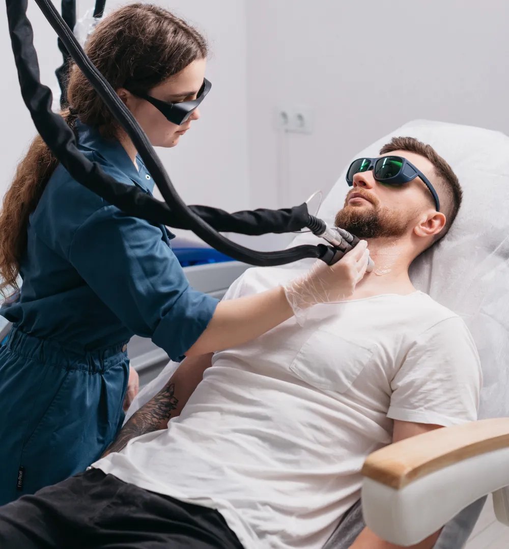 Laser specialist treating a male client's face with the Candela GentleMax Pro in Al Rashidiya, Dubai